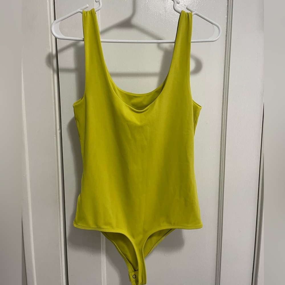 Express Body Contour bodysuit in yellow. Size M, with tags.